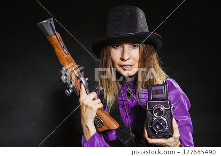 Steampunk with old retro camera and pistol. Steampunk with old retro camera and pistol. 127685490