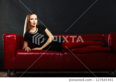 Fashion woman in red pantyhose on couch Fashion woman in red pantyhose on couch 127685491