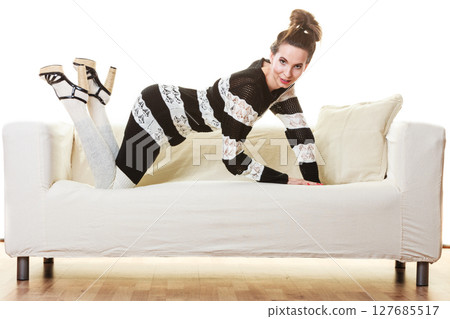 Girl fashionable dress high heels posing on couch. 127685517
