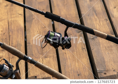 Spinning and reel close up. Professional tackle for catching predatory fish. 127685723
