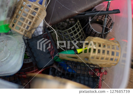 Close-up of different fishing feeder and float, tackle gear box 127685739