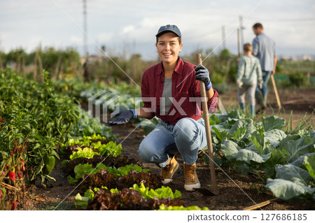 Woman with a hoe in the garden Woman with a hoe in the garden 127686185