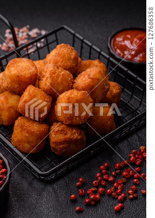 Cheese or potato croquettes, balls fried in breading with salt, spices Cheese or potato croquettes, balls fried in breading with salt, spices 127686358