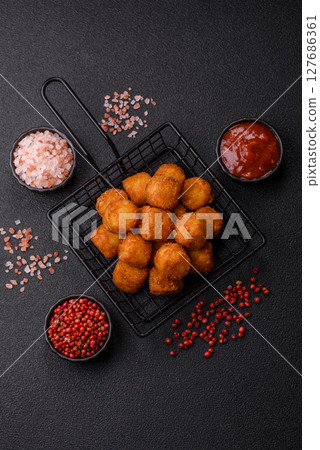 Cheese or potato croquettes, balls fried in breading with salt, spices Cheese or potato croquettes, balls fried in breading with salt, spices 127686361