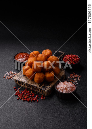 Cheese or potato croquettes, balls fried in breading with salt, spices 127686366