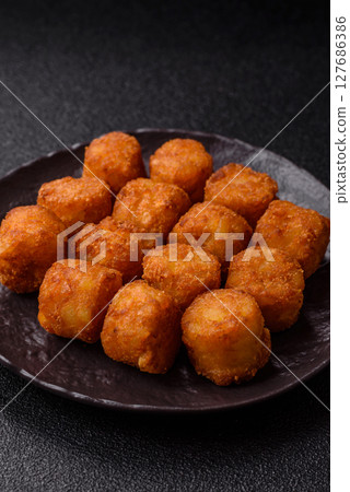 Cheese or potato croquettes, balls fried in breading with salt, spices Cheese or potato croquettes, balls fried in breading with salt, spices 127686386