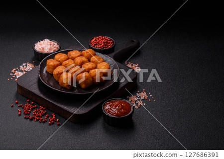 Cheese or potato croquettes, balls fried in breading with salt, spices Cheese or potato croquettes, balls fried in breading with salt, spices 127686391