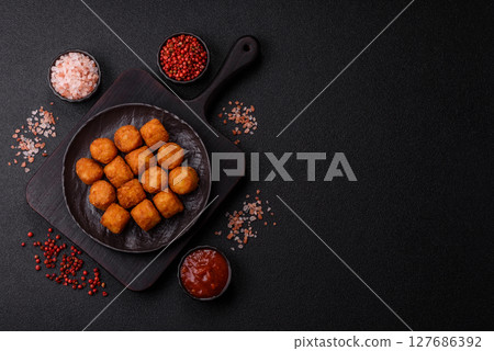 Cheese or potato croquettes, balls fried in breading with salt, spices 127686392