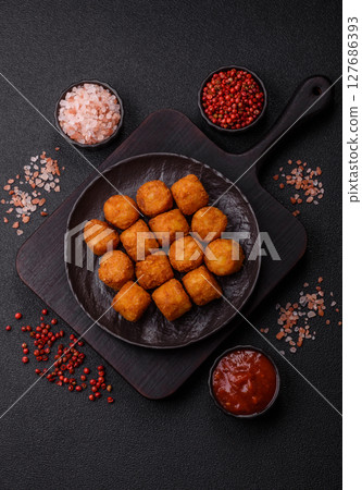 Cheese or potato croquettes, balls fried in breading with salt, spices Cheese or potato croquettes, balls fried in breading with salt, spices 127686393