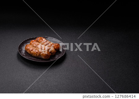 Grilled pork or beef sausages 127686414