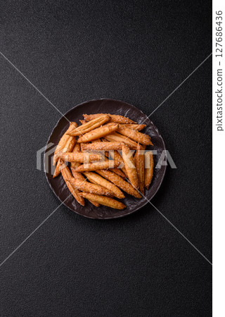 Cinnamon flavored biscuits or breadsticks 127686436
