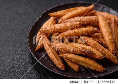 Cinnamon flavored biscuits or breadsticks Cinnamon flavored biscuits or breadsticks 127686438