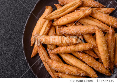 Cinnamon flavored biscuits or breadsticks 127686439