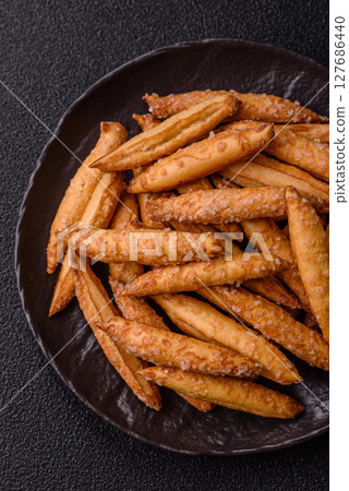 Cinnamon flavored biscuits or breadsticks 127686440