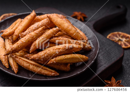 Cinnamon flavored biscuits or breadsticks Cinnamon flavored biscuits or breadsticks 127686456