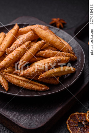 Cinnamon flavored biscuits or breadsticks 127686458