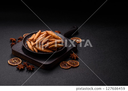 Cinnamon flavored biscuits or breadsticks 127686459