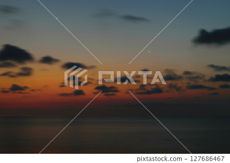 Beautiful sunset in Bali island with visible smiling moon and north star 127686467