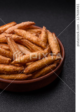 Cinnamon flavored biscuits or breadsticks 127686481