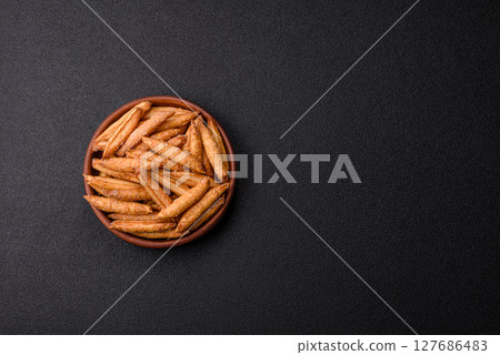 Cinnamon flavored biscuits or breadsticks 127686483