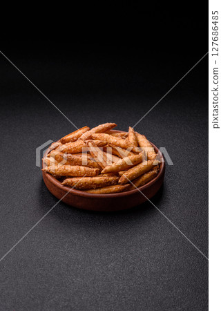 Cinnamon flavored biscuits or breadsticks 127686485