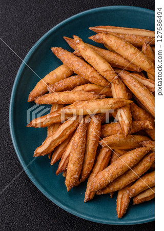 Cinnamon flavored biscuits or breadsticks 127686494
