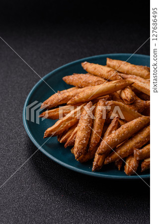 Cinnamon flavored biscuits or breadsticks 127686495