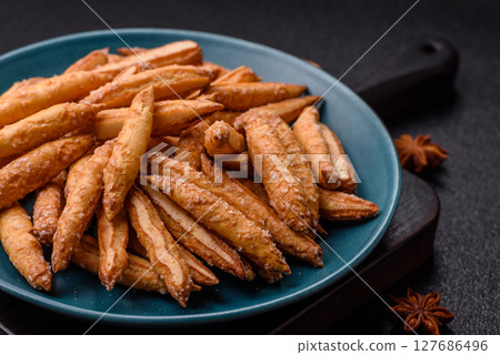 Cinnamon flavored biscuits or breadsticks Cinnamon flavored biscuits or breadsticks 127686496