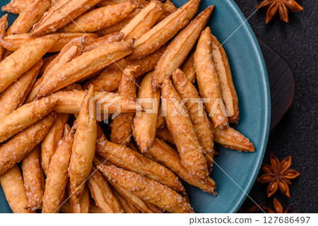 Cinnamon flavored biscuits or breadsticks 127686497