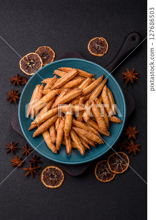 Cinnamon flavored biscuits or breadsticks 127686503