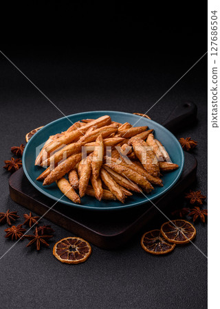 Cinnamon flavored biscuits or breadsticks Cinnamon flavored biscuits or breadsticks 127686504