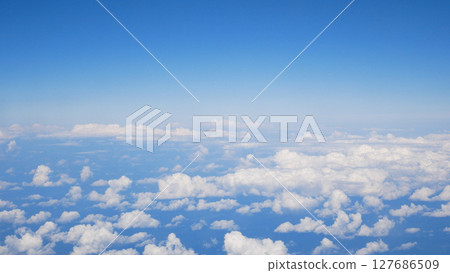 Small white clouds against the background of a blue sky, view from above 127686509