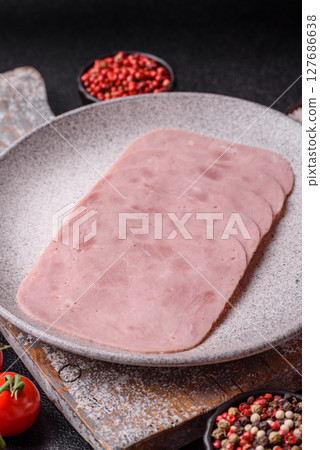 Eating ham and pork slices for the holiday table Eating ham and pork slices for the holiday table 127686638