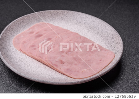 Eating ham and pork slices for the holiday table Eating ham and pork slices for the holiday table 127686639
