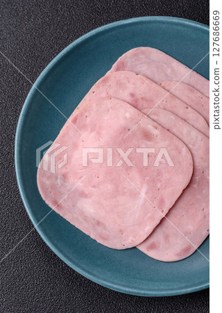 Eating ham and pork slices for the holiday table Eating ham and pork slices for the holiday table 127686669