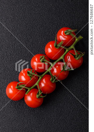 Red cherry tomatoes on a branch, a vegetable as an ingredient for making sauces Red cherry tomatoes on a branch, a vegetable as an ingredient for making sauces 127686687