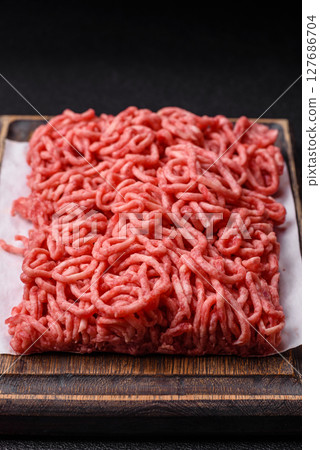 Ground beef mince fresh raw with salt and spices 127686704