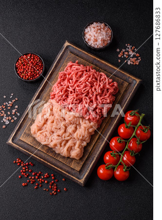 Beef and chicken minced meat, ground of two types fresh raw with salt and spices 127686833