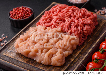 Beef and chicken minced meat, ground of two types fresh raw with salt and spices Beef and chicken minced meat, ground of two types fresh raw with salt and spices 127686835
