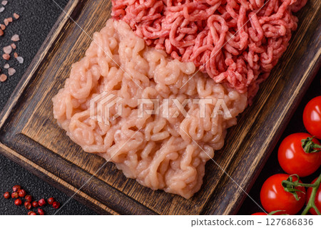 Beef and chicken minced meat, ground of two types fresh raw with salt and spices Beef and chicken minced meat, ground of two types fresh raw with salt and spices 127686836