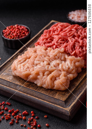 Beef and chicken minced meat, ground of two types fresh raw with salt and spices Beef and chicken minced meat, ground of two types fresh raw with salt and spices 127686838