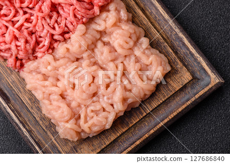 Beef and chicken minced meat, ground of two types fresh raw with salt and spices 127686840