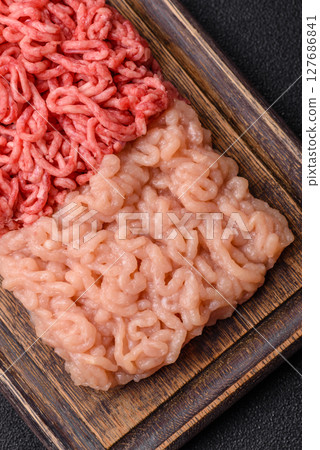 Beef and chicken minced meat, ground of two types fresh raw with salt and spices 127686841