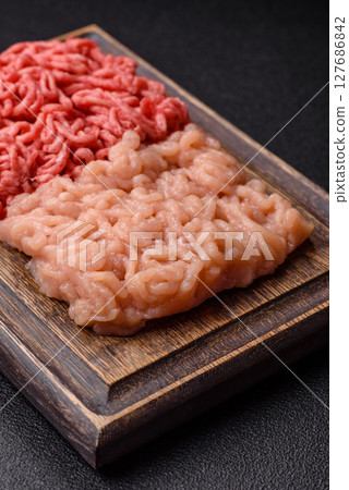 Beef and chicken minced meat, ground of two types fresh raw with salt and spices 127686842