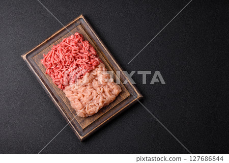 Beef and chicken minced meat, ground of two types fresh raw with salt and spices 127686844
