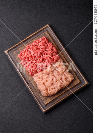 Beef and chicken minced meat, ground of two types fresh raw with salt and spices 127686845