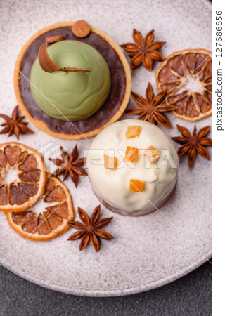 Easter sweet cake covered with icing with fruit and candied fruits 127686856