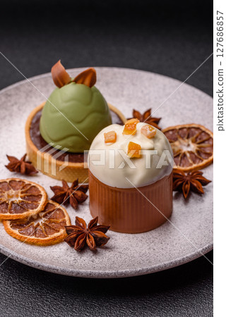 Easter sweet cake covered with icing with fruit and candied fruits 127686857