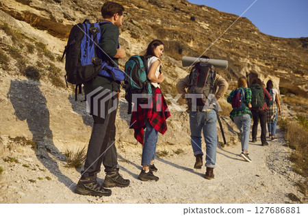 Friends Trekking in Group Amidst Mountain Landscapes 127686881