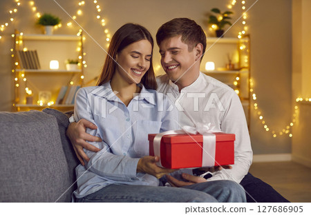 Husband Giving Happy Wife A Gift On Valentine Day 127686905